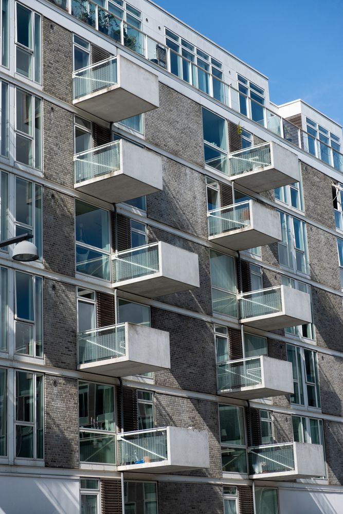Facade of apartment building with patios on sunny day