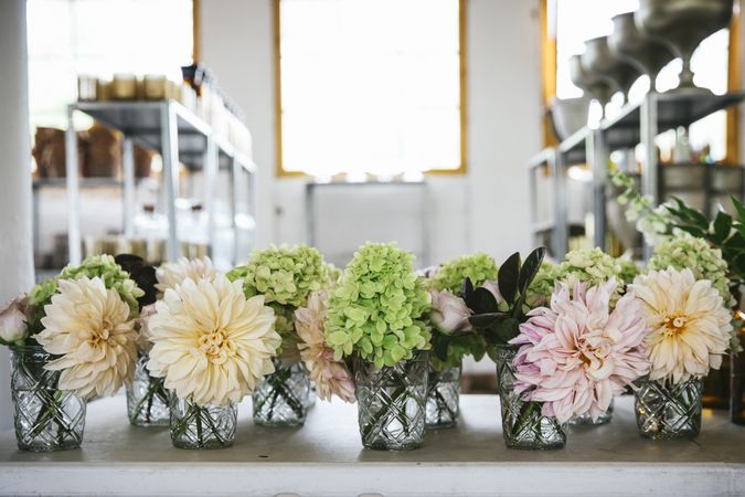 Bunches of flowers in vases on table