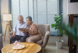 Asian mature couple watching or video call with family
