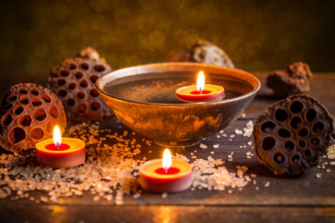 Aromatic candles in bowl on table