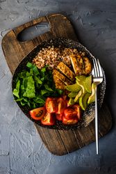 Healthy fresh meal with avocado, grains, tomatoes & spinach