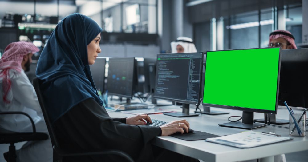Young Middle Eastern Specialist Testing Programming Code for an Innovative Big Data Blockchain Project