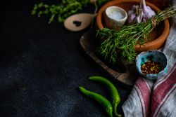 Herbs, garlic and seasoning on counter with copy space