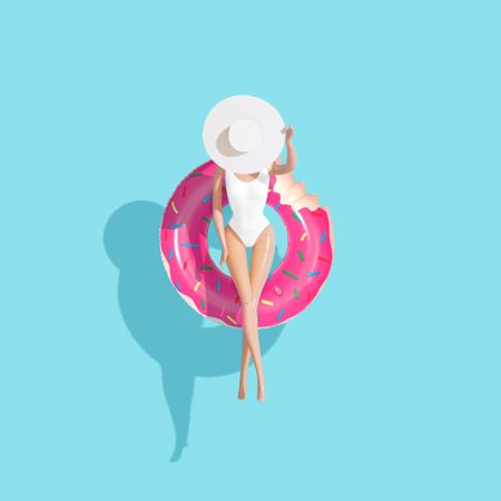 Barbie-like doll in donut ring in pool with blue background