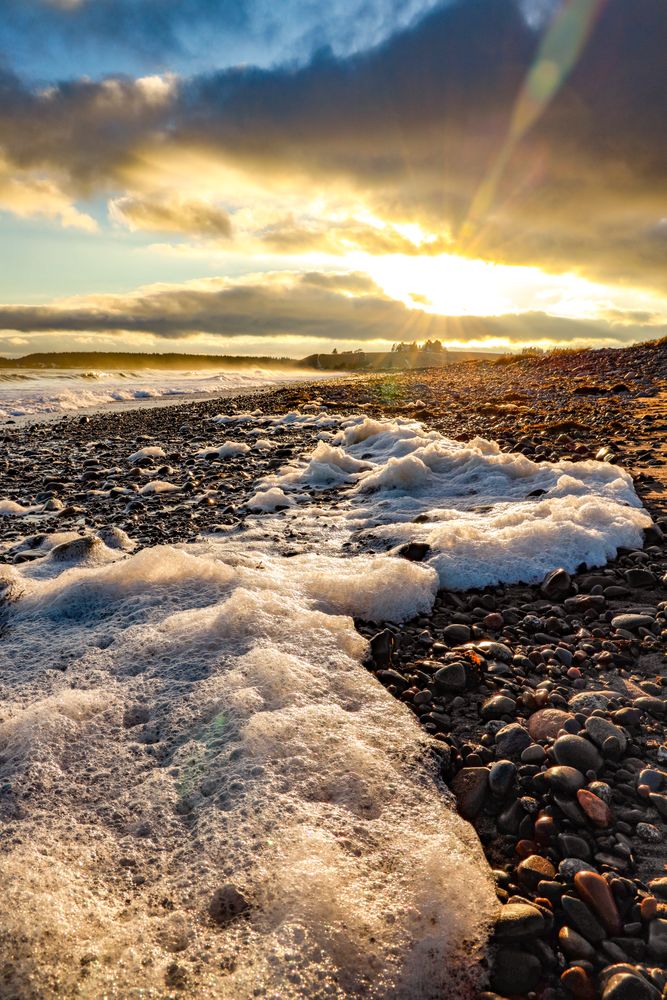 Close-up on waves on beach rocks