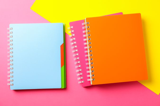 Composition with copybooks on two tone background, space for text