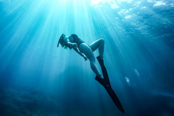 Woman in bathing suit under water