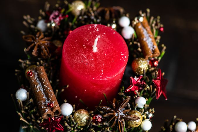 Top view of red Christmas candles with cinnamon and star anise