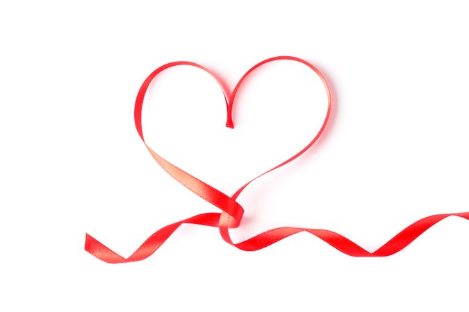 Red ribbon heart isolated on blank background
