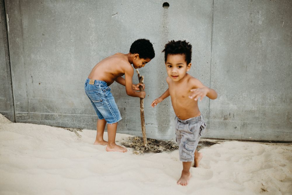 Black boys playing on beach