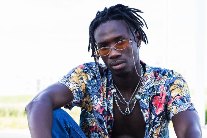 Stylish Black hipster man sitting in city