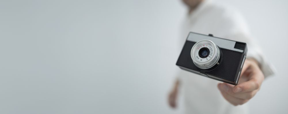 Retro camera floating in hand
