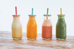 Bottles of yummy smoothies on wooden table