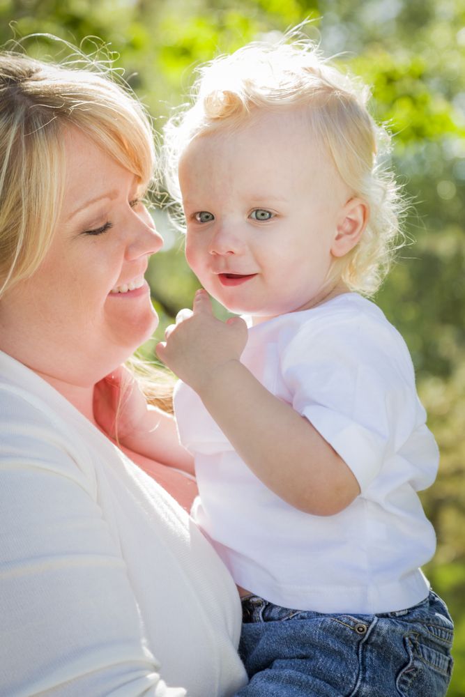 Young Mother Holding Her Adorable Baby Boy