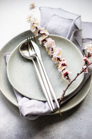 Table setting of apricot blossom branches on elegant ceramic plates