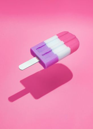 Colorful ice cream popsicle on bright pink background