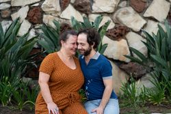 Portrait of loving couple sitting together outside with their faces close together