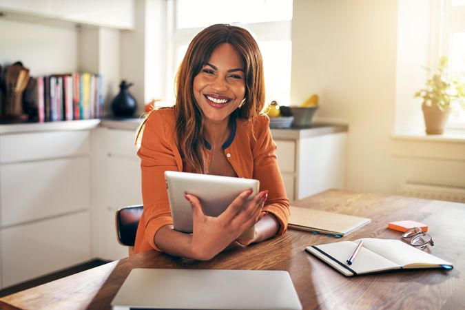 Portrait of businesswoman working at kitchen table