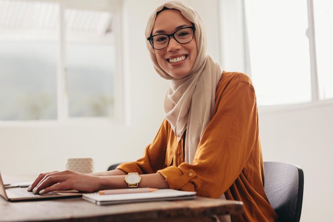Woman wearing hijab working from home