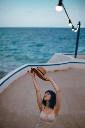Charming woman in sundress walking along pier