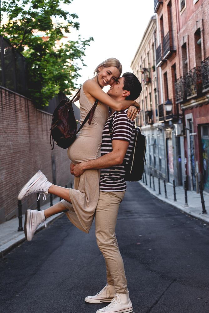 Happy couple having fun while walking in town