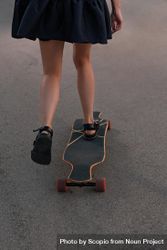Woman in skirt skating on board 0WZVOb