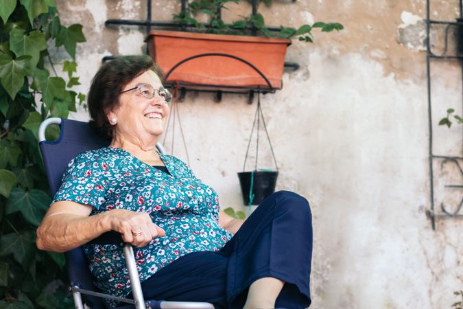 Calm mature woman in patio chair