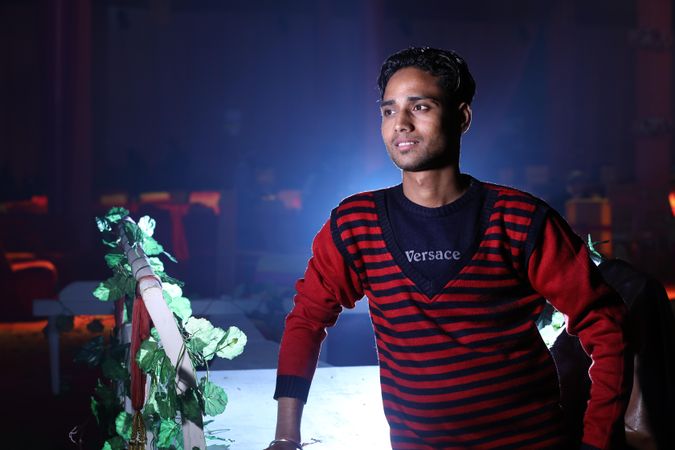 Portrait of young man in red shirt looking away