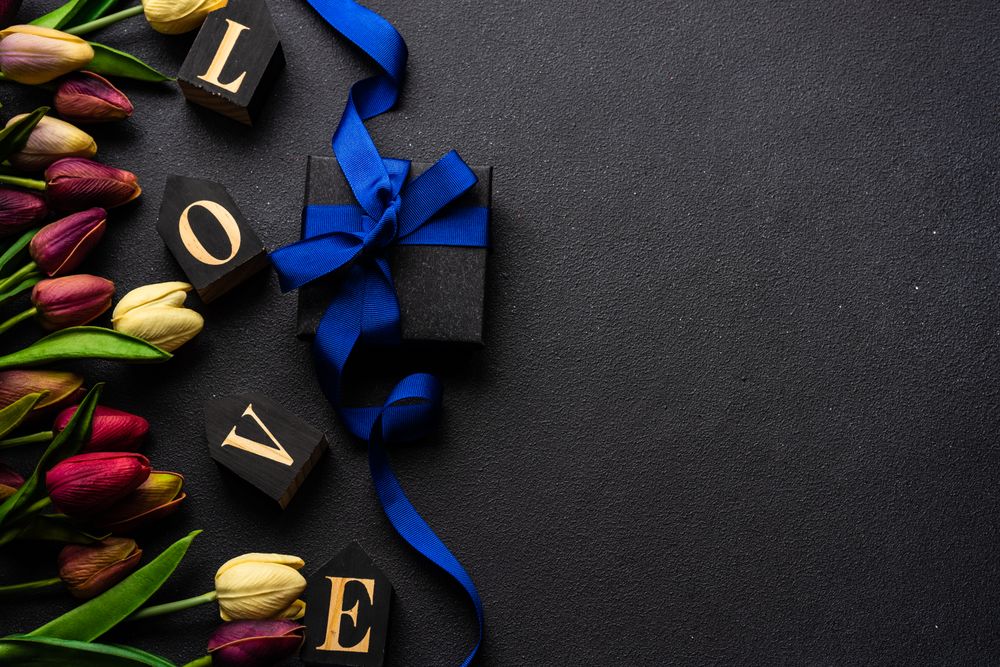 Tulips with the word "love" and present with blue ribbon
