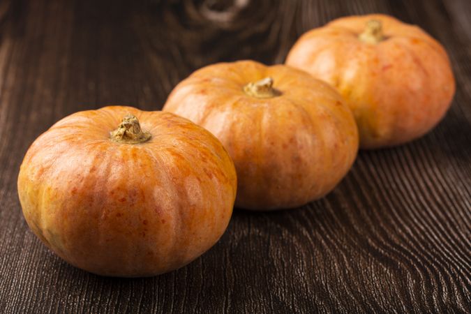 Pumpkins on the wooden table.