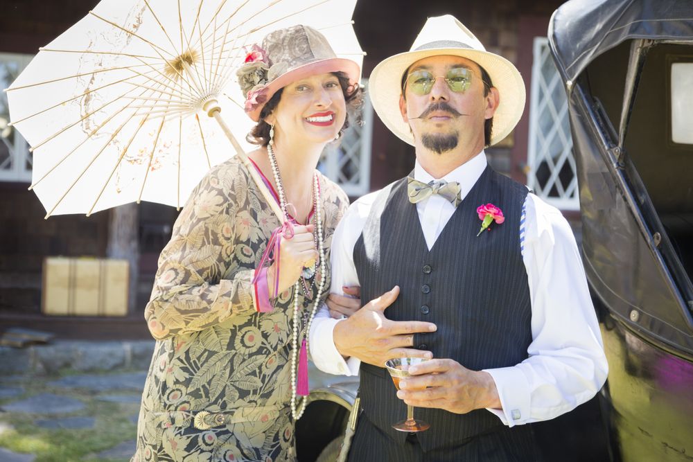 Couple Dressed in 1920’s Era Fashion Sipping Champagne