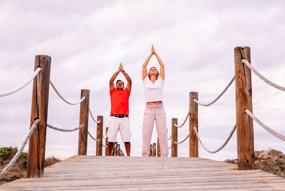 Couple practicing martial arts on lumber path