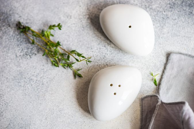 Top view of salt and pepper shakers on marble background