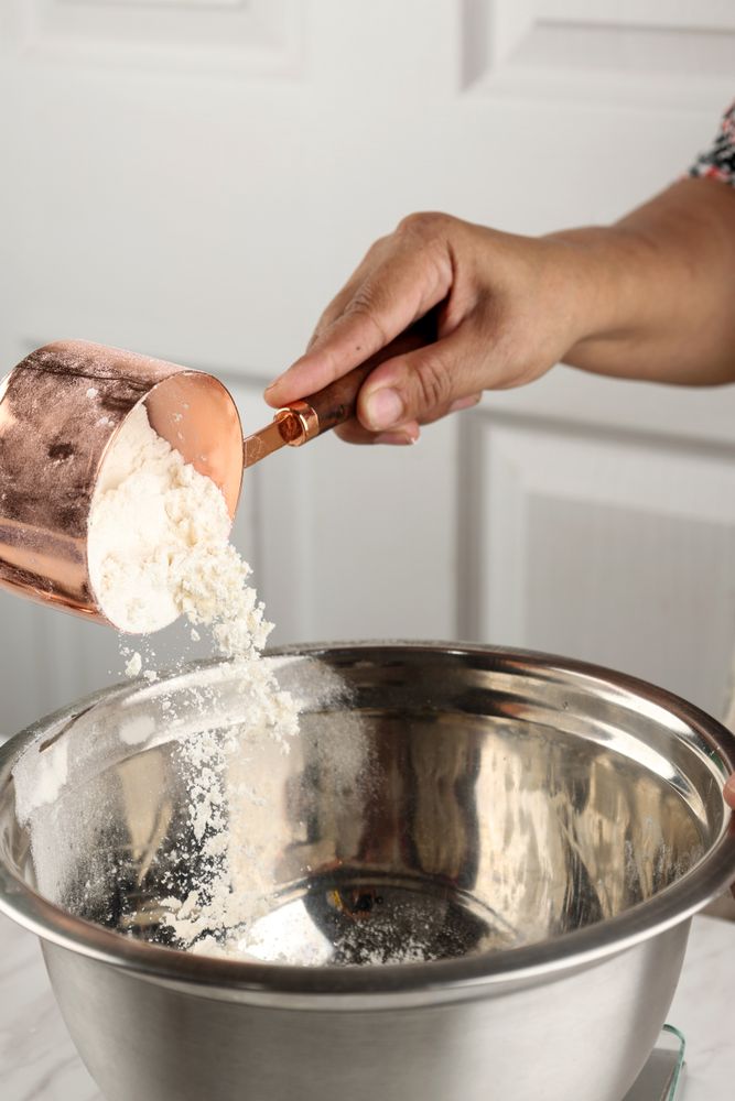 Baking Concept Pouring Flour to Stainless Mixing Bowl