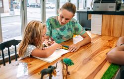 Mother and daughter drawing together