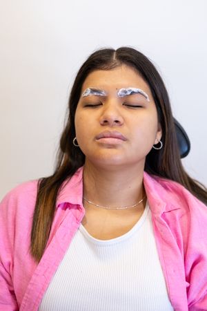 Beautician making eyebrow design and lamination procedures