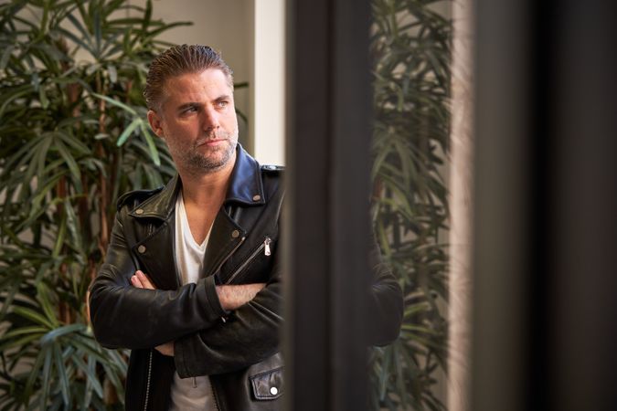 Confident mature brutal man with arms crossed