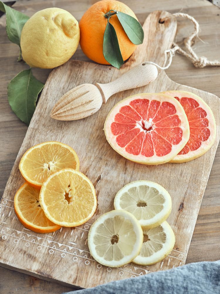 Fresh drink and sliced fruits on cutting board