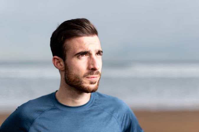 Sportsman resting on beach