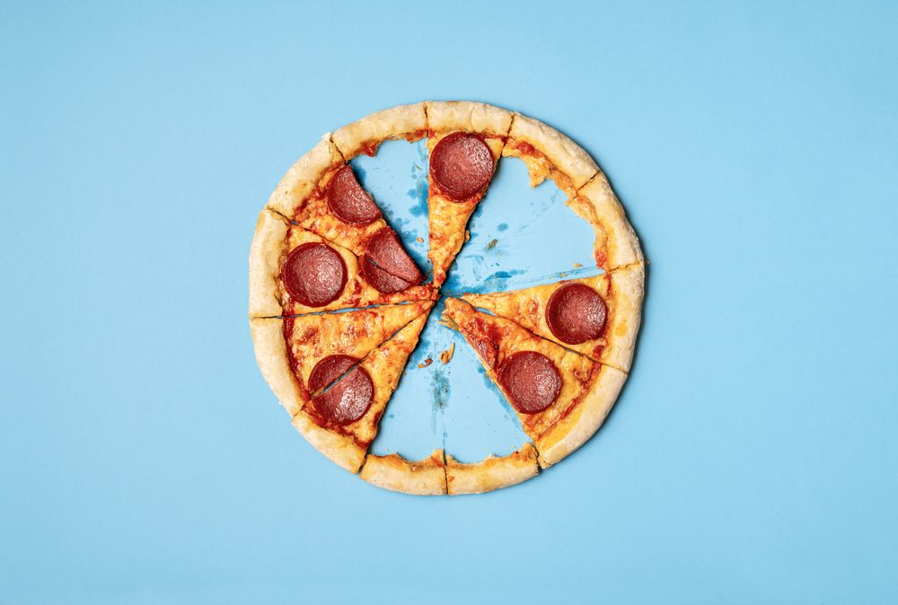 Salami Pizza with missing slices and leftover crust