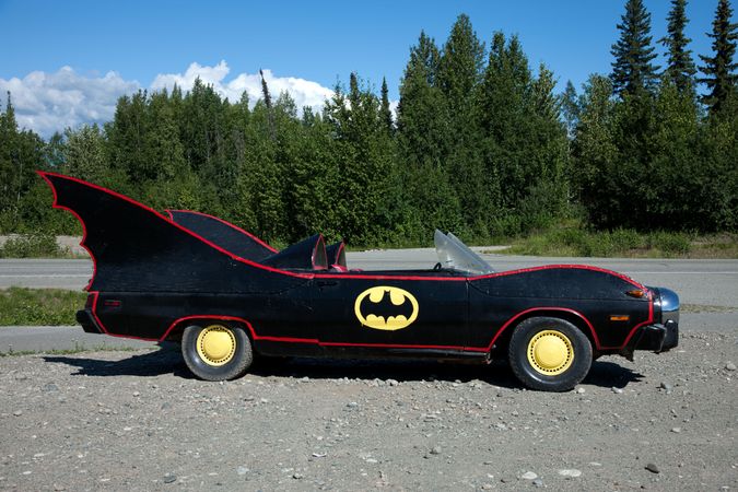 Retro Batmobile parked near forest in Alaska