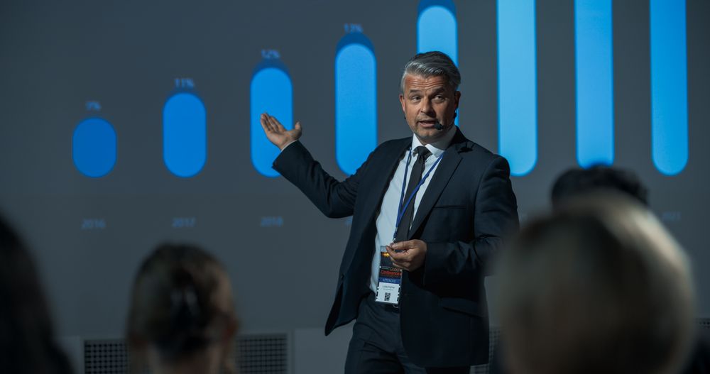 Corporate Event: Male Tech CEO Giving Presentation To Colleagues or Investors In Conference Room Of Innovative Startup Office.