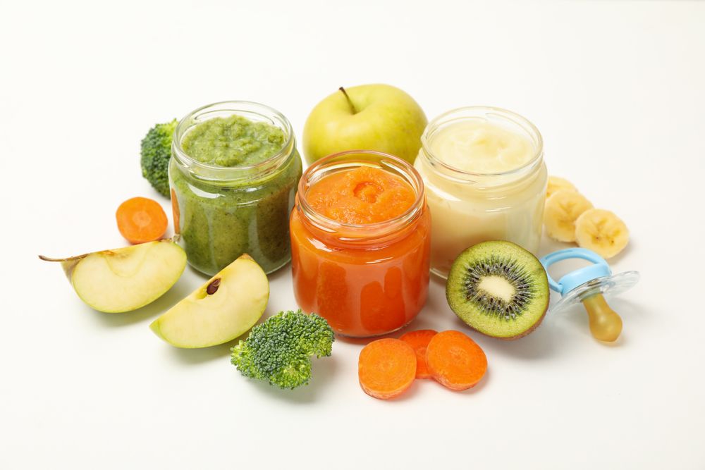 Composition with baby food on plain background. Vegetable puree