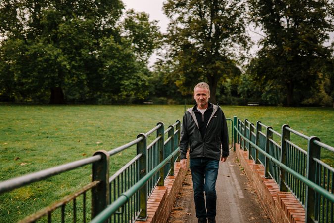 Man walking on footbridge in park