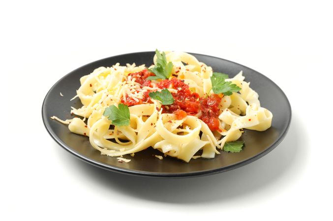Plate with tasty pasta isolated on plain background