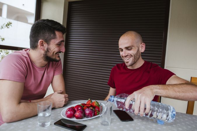 Gay couple eating strawberries