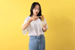 Young Indonesian Teenager Eating Instant Noodles using Chopstick