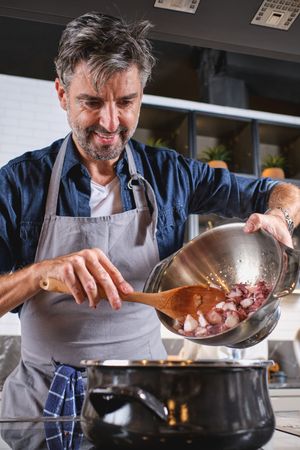 Adult man cooking in kitchen