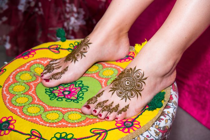 Indian bride's henna tattooed feet on cushion
