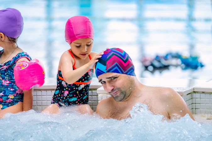 Family relaxing in bubbling pool